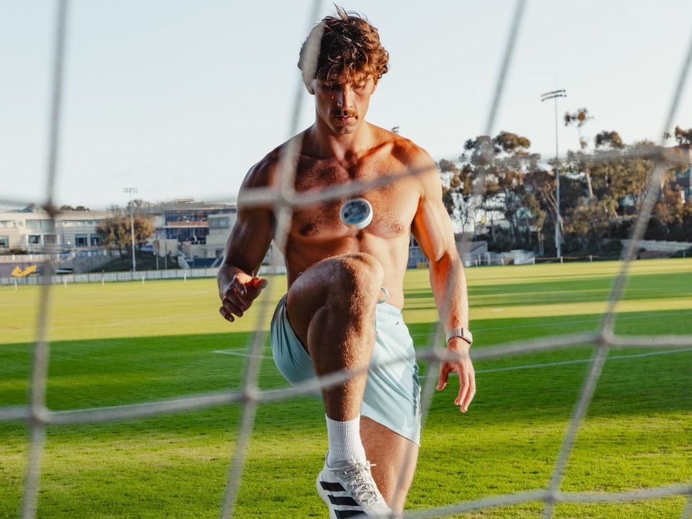 Holding a tin of ZALT out on a soccer field