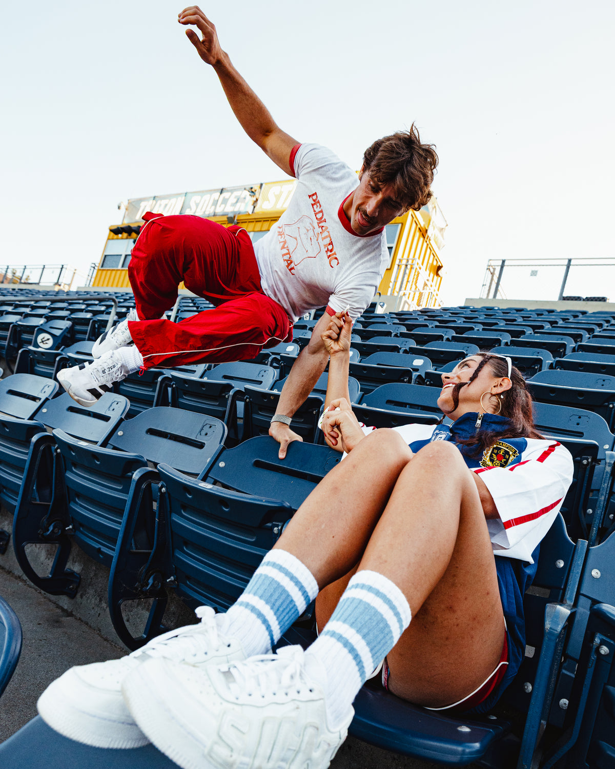 Two friends messing around in stadium seats, ZALT in hand
